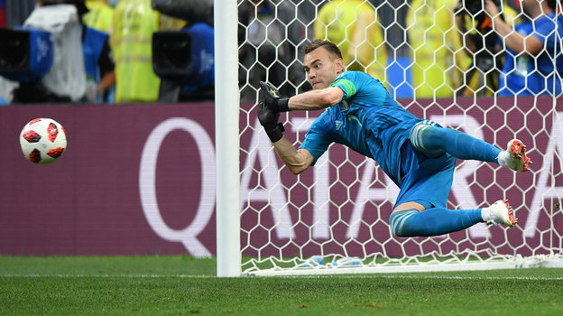 Igor Akinfeev reflects a penalty in a match against Spain