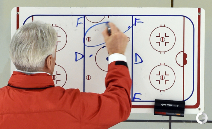 хоккейный тренер объясняет тактику игроку